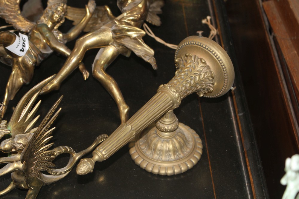 A pair of gilt bronze angel hanging light fittings, height 39cm, a torch wall light, 26cm and a pair of brass dragon chambersticks, 16c